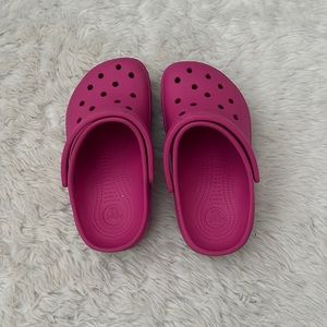 Kids pink crocs with blue line under
